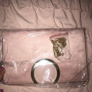 Pink clutch with chain attachment